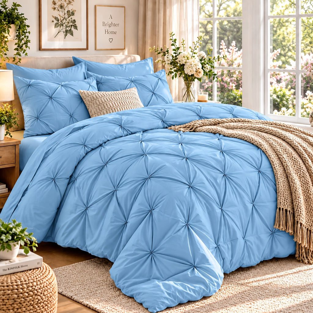 Light blue pinch pleat comforter set on a bed