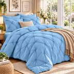 Light blue pinch pleat comforter set on a bed