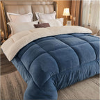 Blue plush box quilted comforter with ivory fleece reverse on a bed