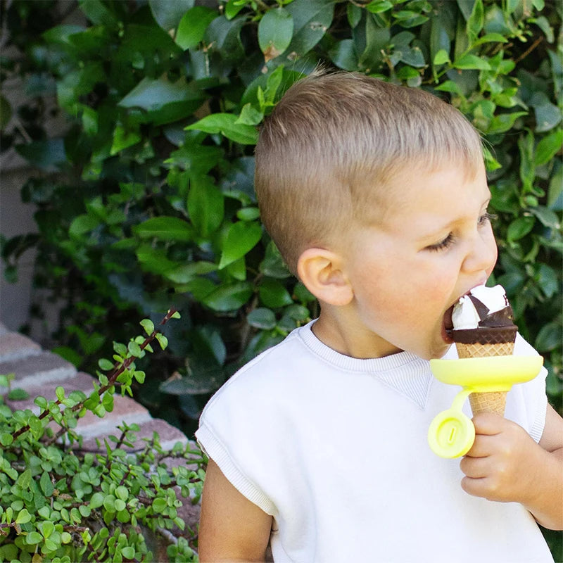 Yellow popsicle holder being used beneath an ice cream cone
