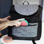 Popsicle holder being tucked into a bag pocket