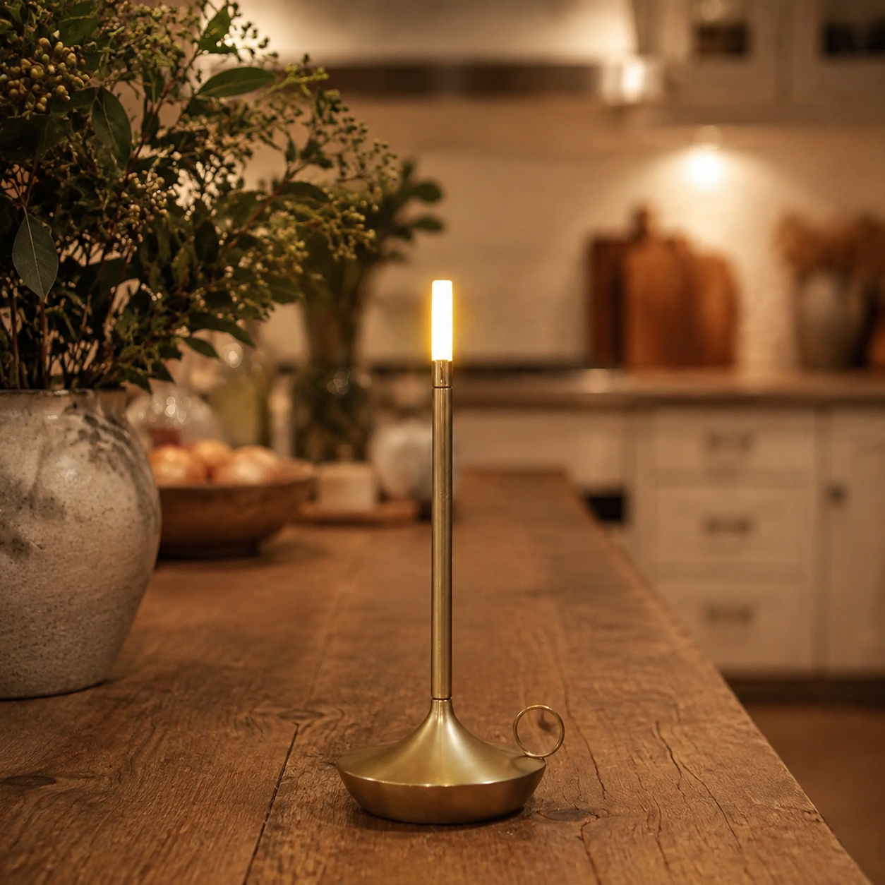 Gold portable table lamp centered on a wooden kitchen island.
