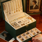 Dark green jewelry box with a drawer pulled forward