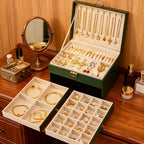 Green jewelry box with removable tray set beside it