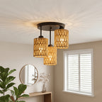 Rattan ceiling light with three woven cylinder shades and a black metal mount.