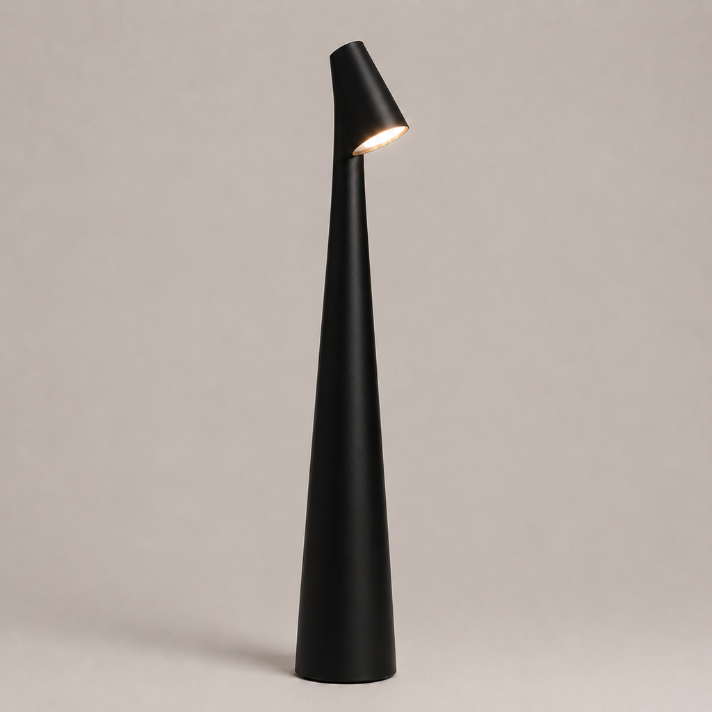Black table lamp with a tapered cone body and angled light head on a neutral studio background.