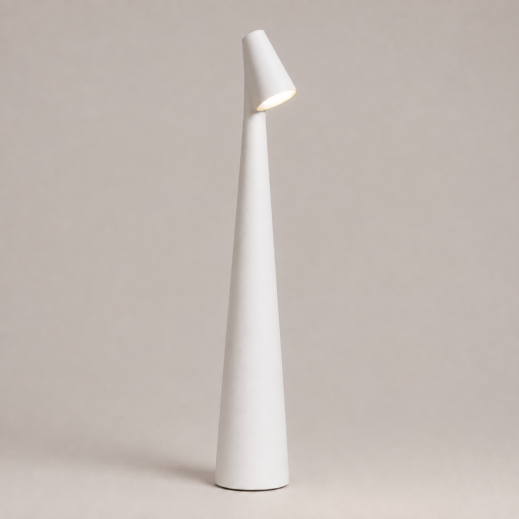 White table lamp with a tapered cone body and angled light head on a neutral studio background.