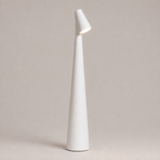 White table lamp with a tapered cone body and angled light head on a neutral studio background.