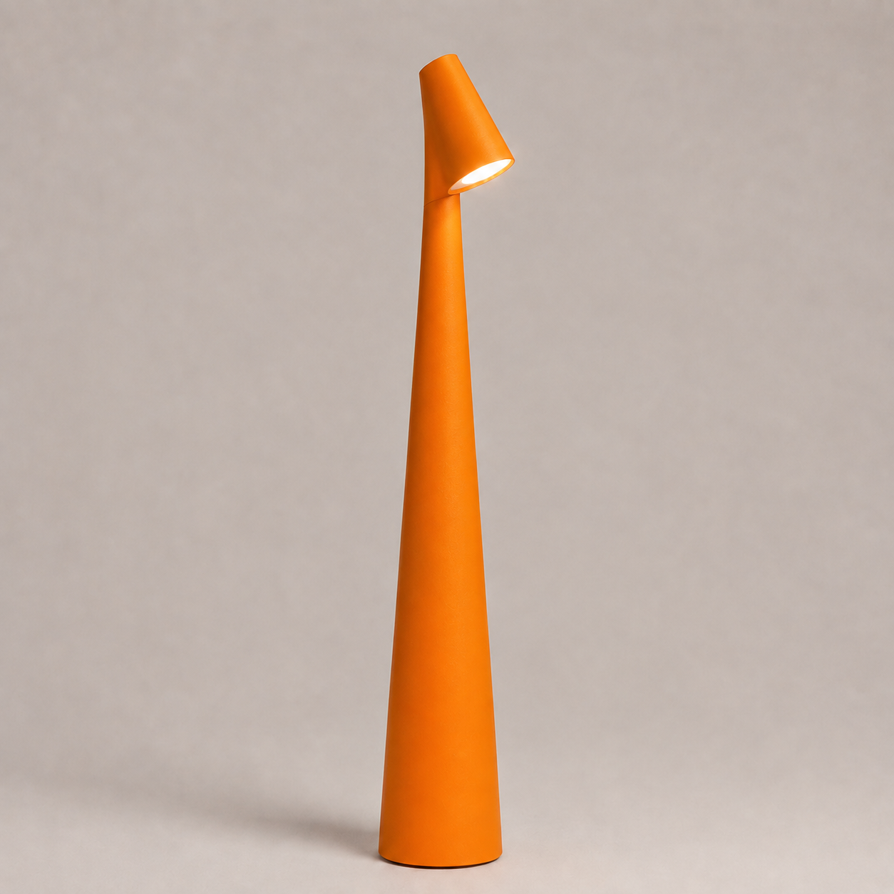 Orange table lamp with a tapered cone body and angled light head on a neutral studio background.