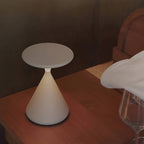 White rechargeable table lamp viewed from above on a wood table.