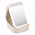 Open white travel makeup case with integrated mirror on white background