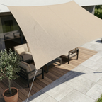 Beige rectangular shade sail stretched above outdoor furniture.