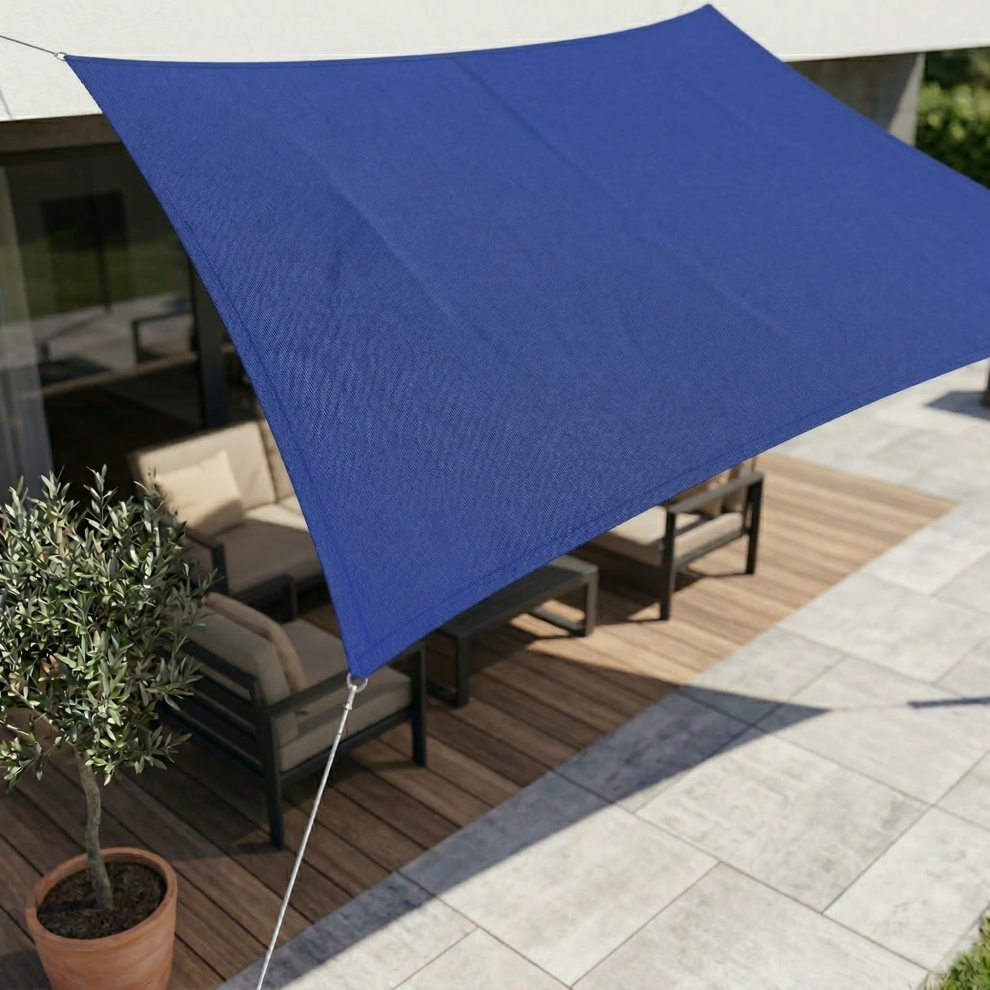 Blue rectangular shade sail installed above a patio table.