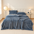 Dark Gray broad ribbed plush blanket on a bed