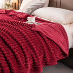 Burgundy ribbed throw with its reverse side visible