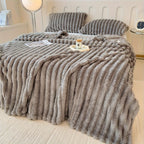 Gray broad ribbed blanket on a bed