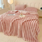 Pink broad ribbed blanket on a bed