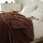 Coffee brown ribbed blanket spread across a bed