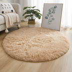 Camel round area rug styled on a light wood floor.