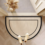 Semicircle door mat with black border and geometric center pattern.