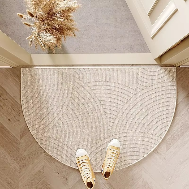 Beige semicircle door mat with layered arch pattern.