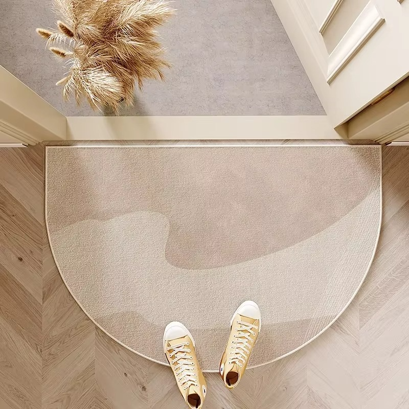 Neutral semicircle door mat with soft abstract shapes.