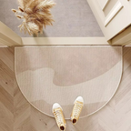 Neutral semicircle door mat with soft abstract shapes.