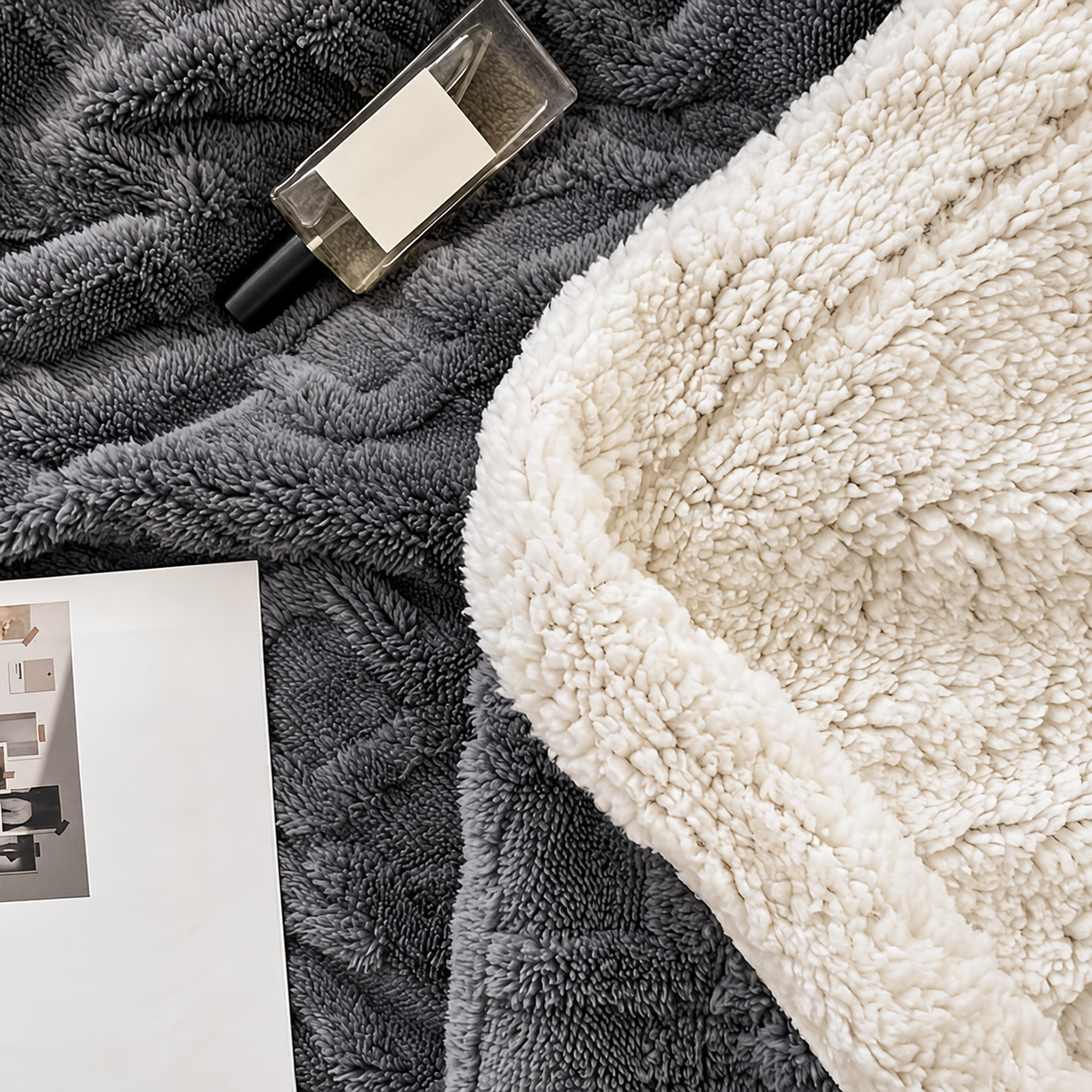 Jacquard sherpa throw blanket close up showing dark gray textured front and white reverse