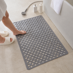 Non slip shower mat in gray shown full length as a hand checks the surface