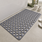 Non slip shower mat in gray laid flat beside a white bathtub