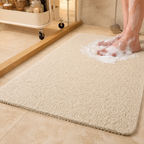 Loofah shower mat in beige beneath wet feet in a warm tiled bathroom