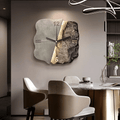 Beige split-stone wall clock with sculpted relief in a modern dining room