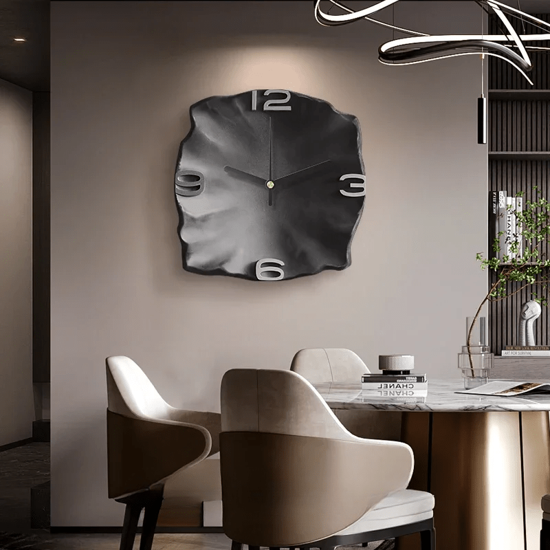Black sculpted wall clock in a modern dining room