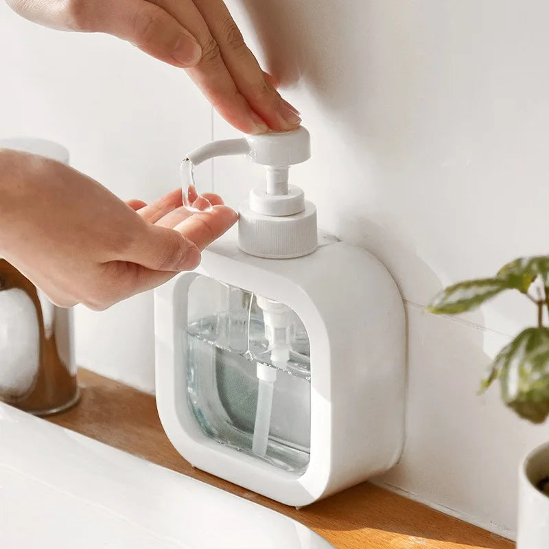 White soap dispenser delivering liquid into an open hand.