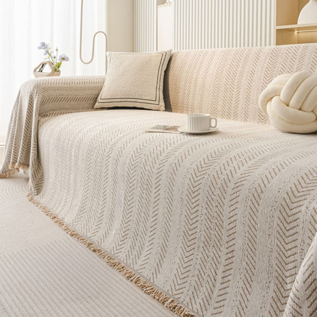 Sofa cover in almond cream chenille draped over a sofa with matching cushion.