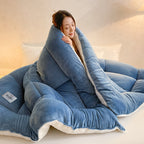 Blue plush comforter wrapped around a woman