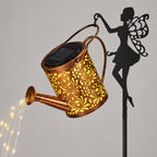 Solar-powered fairy garden light shaped like a copper watering can, with a butterfly silhouette stake and warm white LED lights glowing.