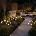 Warm white solar garden lights lining a landscaped patio path at dusk.