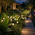 Warm white solar garden lights lining a path beside a reflecting pond.