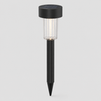 A solar-powered ground stake light with a black top cap, clear ribbed glass shade, and black stake, shown against a light gray background.