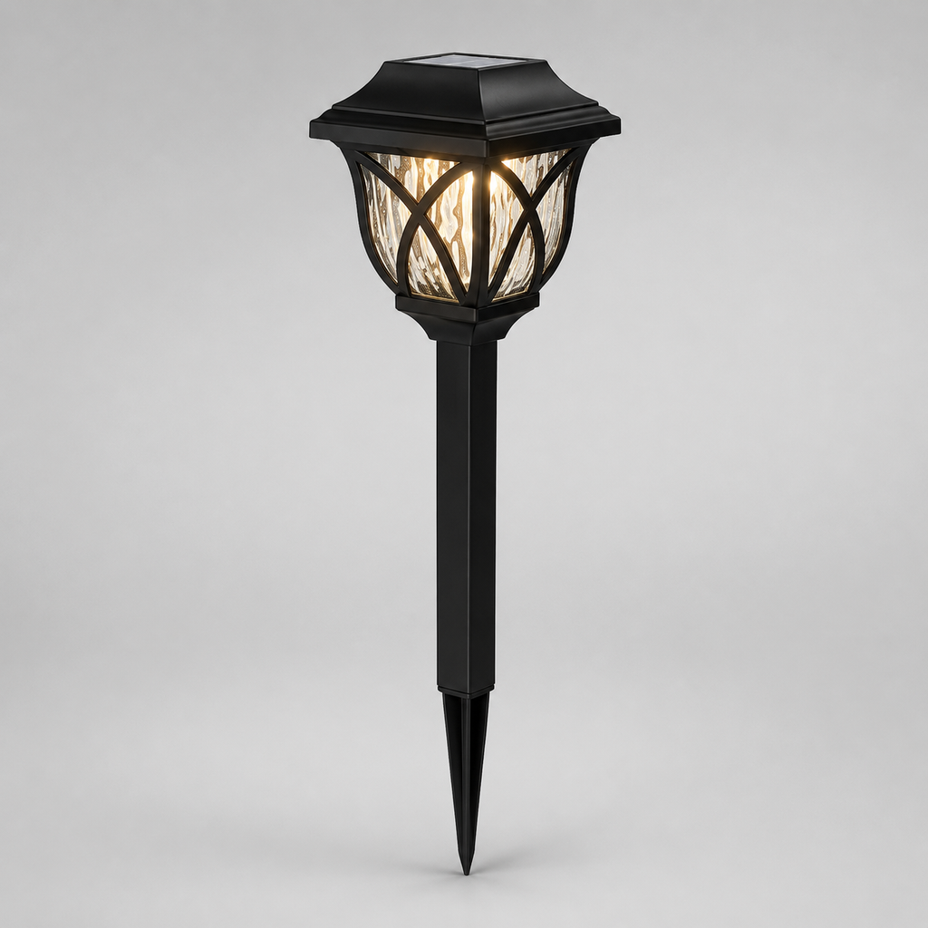 A black solar-powered outdoor landscape light with a pointed stake base and a textured glass shade, shown illuminated against a neutral gray background.