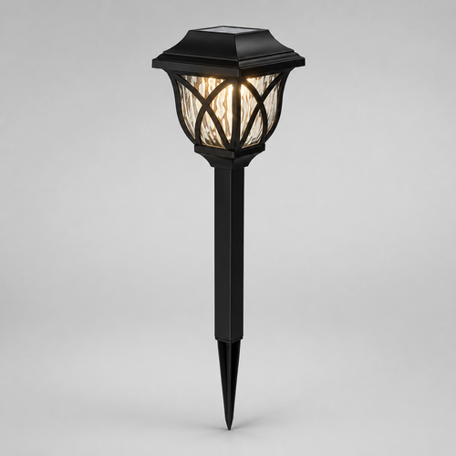 A black solar-powered outdoor landscape light with a pointed stake base and a textured glass shade, shown illuminated against a neutral gray background.