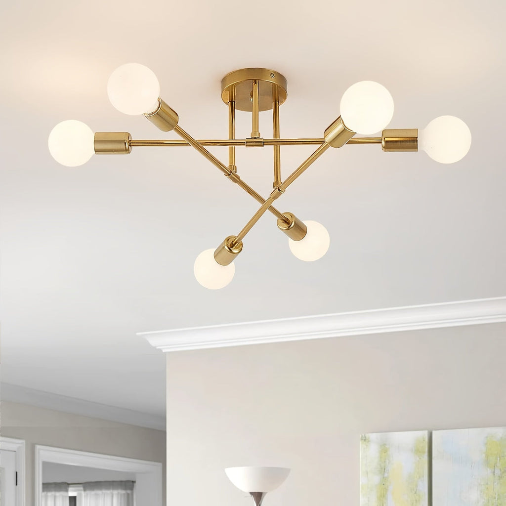 Gold Sputnik ceiling light with six globe bulbs installed close to a white ceiling.