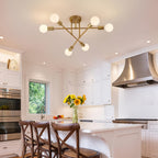 Gold Sputnik ceiling light above a kitchen island and dining area.