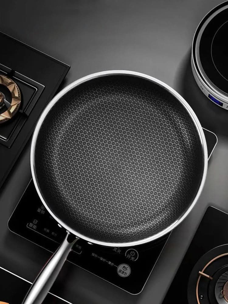 Stainless steel 316 frying pan with a double-sided honeycomb surface, lifestyle view.