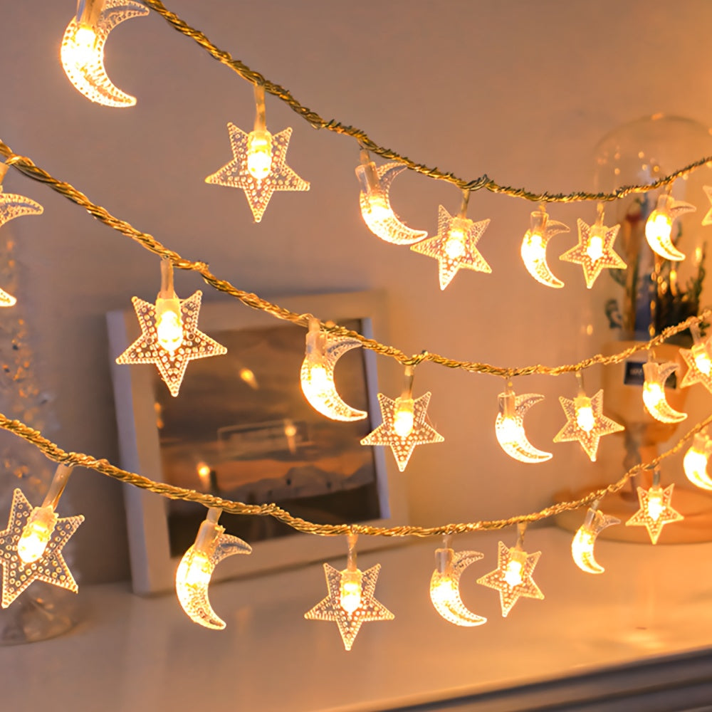 Star and moon fairy lights hanging in front of a softly lit wall.