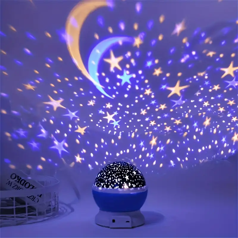 Blue star projector casting colorful moon and star patterns in a room.