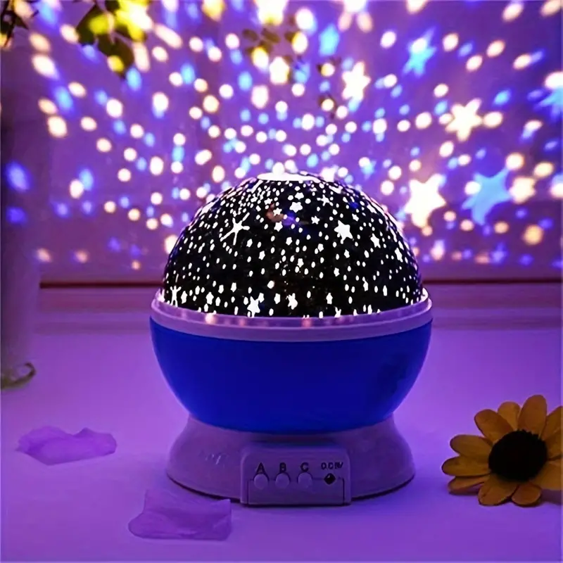 Blue star projector with a dark star patterned dome and purple colored illumination.