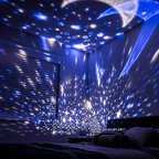 Star projector casting blue light patterns across the walls and ceiling of a bedroom.