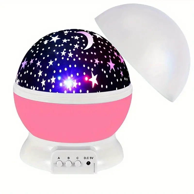 Pink star projector with a removable white dome cover and three buttons on its base.